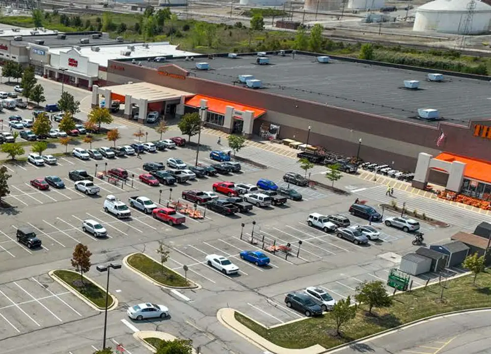 home-body-1 Shopping center parking lot with parked cars.