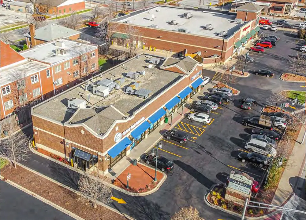 home-body-2 Aerial view of commercial buildings and parking.